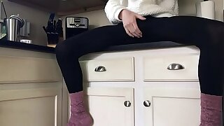 Sissy in socks and leggings playing on the counter